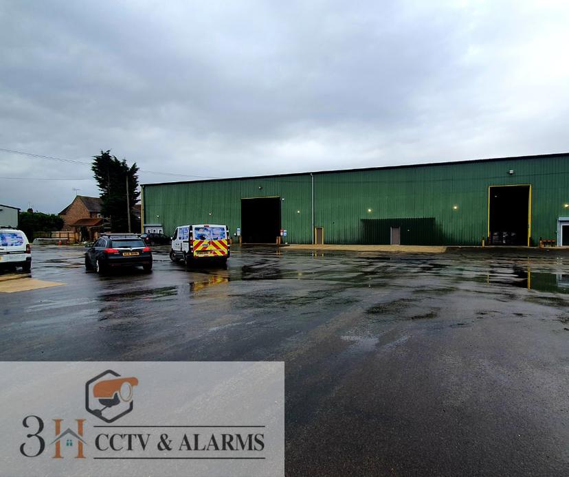Six security lights illuminating commercial yard with vans
